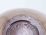 a close up of a metal object with a white background