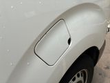 a close up of a white truck with a hole in the side