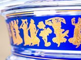 a close up of a blue vase with gold designs on it