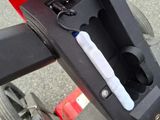 a toothbrush in the holder on the handlebar of a scooter