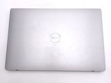 a silver laptop with a smiley face on the screen