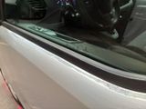 a close up of a car ' s door handle and steering wheel