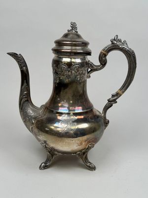 une théière ancienne en argent, munie d'une anse et d'un couvercle