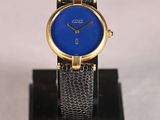 an image of a blue watch on a black stand