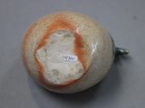 a ceramic ball with a hole in it on a table