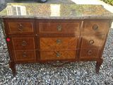 an antique dresser with marble top and drawers