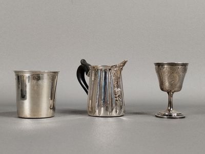 three silver cups sitting next to each other on a table