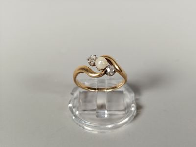 a gold ring with a pearl and a diamond on it