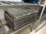a man that is standing in front of a rack of metal items