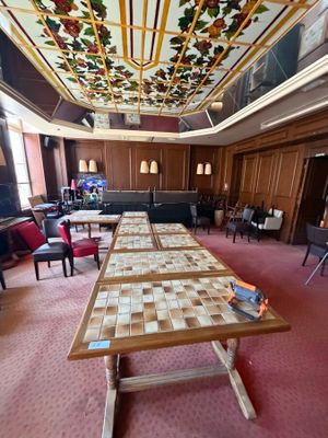 a long table in a room with many chairs and tables