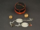 a small box with a chain and a coin on a table