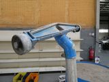 a blue pipe that is attached to a pole in a garage