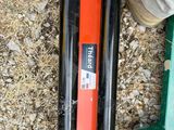 a pair of skis sitting on the ground next to a person ' s feet