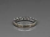 a close up of a wedding ring on a reflective surface