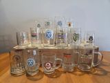 a lot of beer glasses sitting on a wooden table