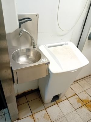 a dirty bathroom with a sink and a toilet in it