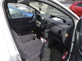 a white car with a black seat in the back of it