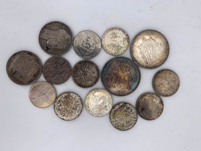 a close up of a pile of old coins on a white surface
