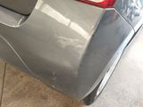 a close up of a car ' s rear bumper with a denting on it