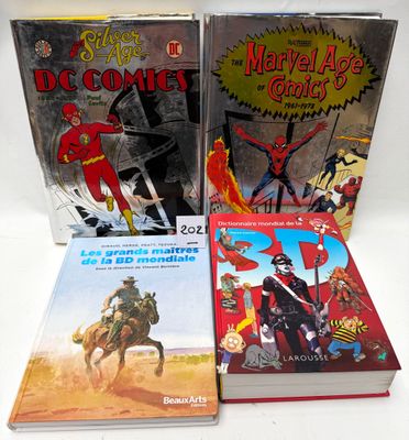 three books of comics are sitting on a white surface