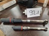 two wrenches on a table with a price tag on it