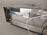 a metal box with wires attached to it on a table