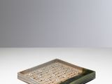 the square tray is made of glass and has a green base