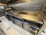 a large commercial kitchen with stainless steel counter tops