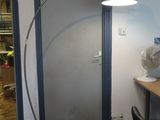 un bureau avec une lampe et un ventilateur dans une pièce