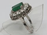 a close up of a ring with a green stone on it
