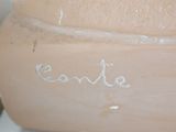 a close up of a clay vase with writing on it