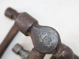 a close up of a wrenet and a hammer on a table
