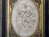 an ornate gold frame with a drawing of a woman and a man