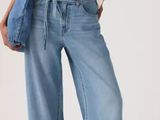 an image of a woman in a white shirt and blue jeans