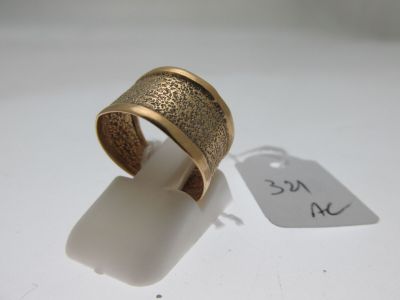 a close up of a gold ring with a price tag on it