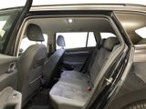 the back seats of a car with the door open and the driver ' s seat folded down