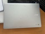 a laptop computer sitting on a desk next to a keyboard