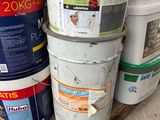 several buckets of paint sitting on top of a wooden pallet
