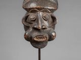 a wooden head of a man with a beard on a stand
