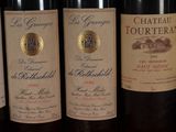 several bottles of wine are lined up on a table