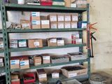 many boxes and tools on a shelf in a garage