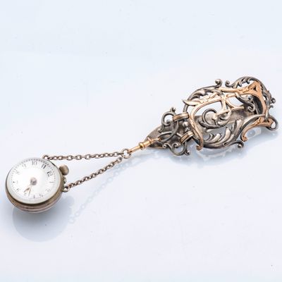 une montre à gousset en argent à laquelle est attachée une chaîne
