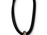 a black leather necklace with a silver flower on a white background
