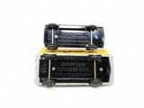 two pieces of black plastic with a yellow label on them