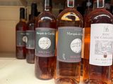 bottles of wine are lined up on a shelf in a store