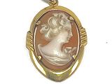 an image of a woman ' s profile is shown in a gold - plated pendant