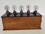 an image of a wooden box with five light bulbs on it