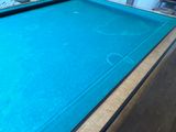 a pool table with a blue pool in the middle of it