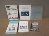 four books are sitting on a table next to each other