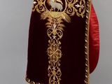 an image of a red and gold robe with a cross on it